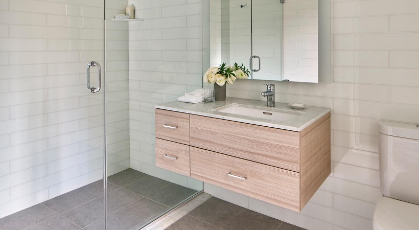 spacious bathroom with modern, floating sink and walk-in shower
