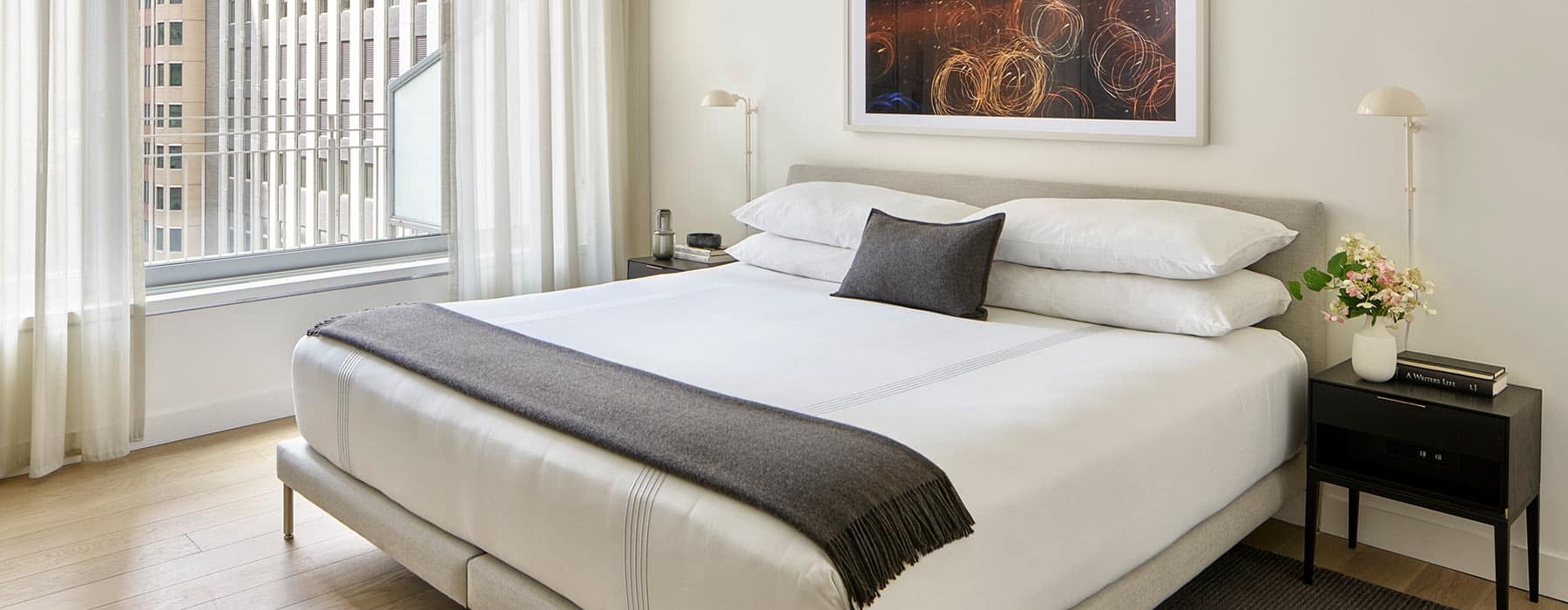spacious bedroom with large windows that allow ample, natural lighting into room